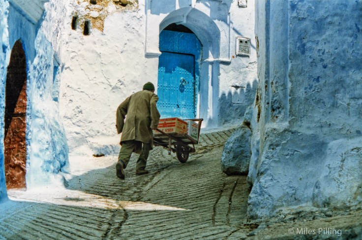 Pushing goods up a hill in Chefchaouen, Morocco